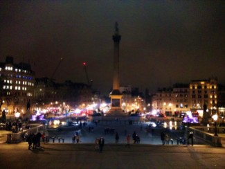 This is a night time view of the square in front of the National Gallery in Central London.