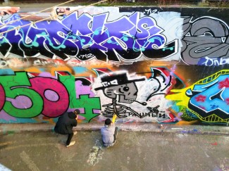 This picture shows some men painting graffiti in a tunnel near Waterloo Station.